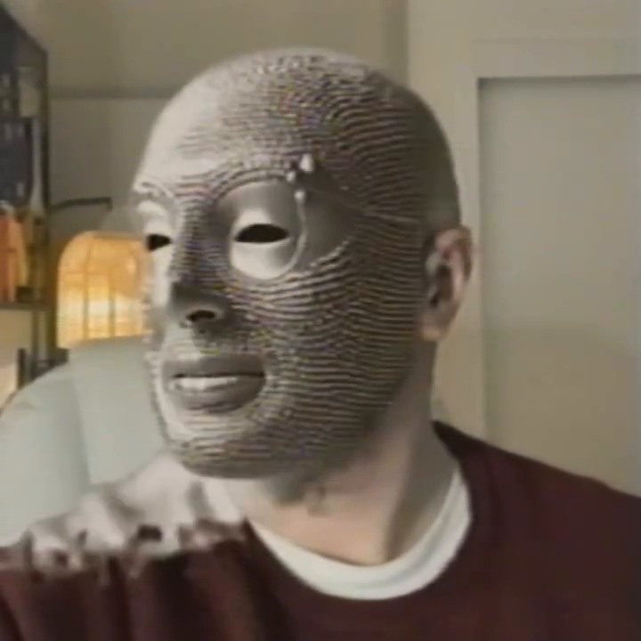 His face is fully converted to pins, his ear and neck still skin.