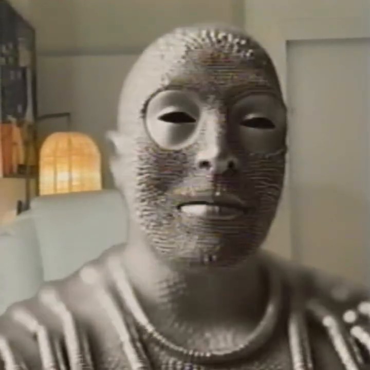 A featureless pin sculpture of a head and shoulders in the same room.